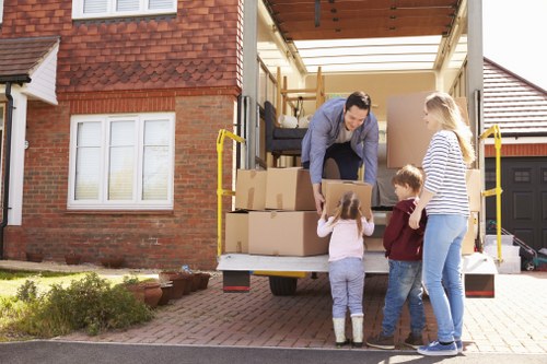 Moving team handling boxes safely during a van service